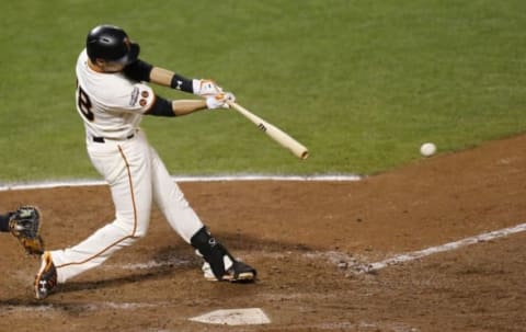 Oct 10, 2016; San Francisco, CA, USA; San Francisco Giants catcher Buster Posey (28) hits a single against the Chicago Cubs in the fifth inning during game three of the 2016 NLDS playoff baseball series at AT&T Park. Mandatory Credit: John Hefti-USA TODAY Sports