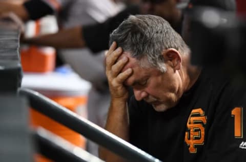 PHOENIX, AZ – AUGUST 05: Manager Bruce Bochy #15 of the San Francisco Giants rests his head in his hand while sitting in the dugout during the third inning of a game against the Arizona Diamondbacks at Chase Field on August 5, 2018 in Phoenix, Arizona. (Photo by Norm Hall/Getty Images)