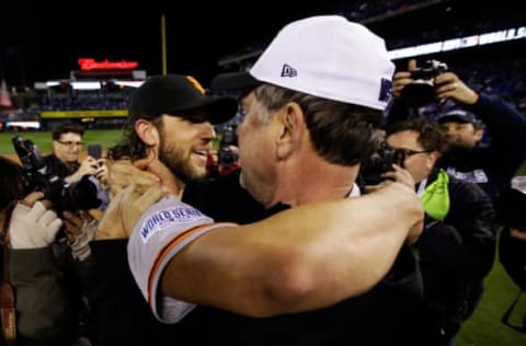 KANSAS CITY, MO – OCTOBER 29: Manager Bruce Bochy #15 of the San Francisco Giants celebrates on the field with Madison Bumgarner #40 after defeating the Kansas City Royals 3-2 to win Game Seven of the 2014 World Series at Kauffman Stadium on October 29, 2014 in Kansas City, Missouri. (Photo by Ezra Shaw/Getty Images)