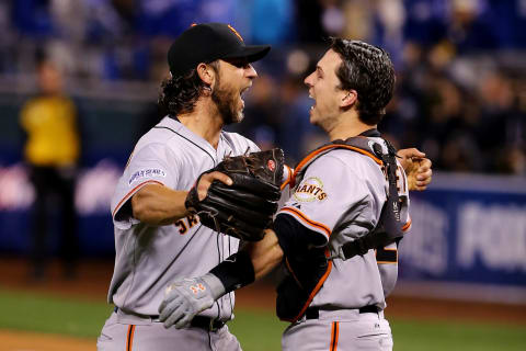 KANSAS CITY, MO – OCTOBER 29: Buster Posey #28 and Madison Bumgarner #40 of the San Francisco Giants celebrate after defeating the Kansas City Royals to win Game Seven of the 2014 World Series by a score of 3-2 at Kauffman Stadium on October 29, 2014 in Kansas City, Missouri. (Photo by Elsa/Getty Images)