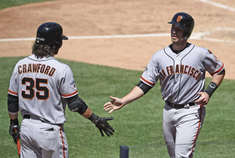 SAN DIEGO, CA – JULY 22: Buster Posey #28 of the San Francisco Giants, right, is congratulated by Brandon Crawford #35 after scoring during the seventh inning of a baseball game against the San Diego Padres at Petco Park July 22, 2015 in San Diego, California. (Photo by Denis Poroy/Getty Images)