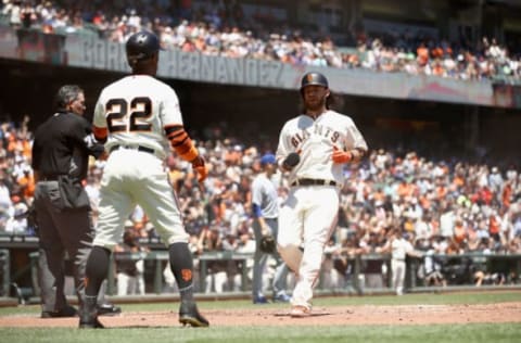 SAN FRANCISCO, CA – JULY 11: Andrew McCutchen #22 and Brandon Crawford #35 of the San Francisco Giants both score on a hit by Gorkys Hernandez #7 of the San Francisco Giants in the first inning against the Chicago Cubs at AT&T Park on July 11, 2018 in San Francisco, California. (Photo by Ezra Shaw/Getty Images)