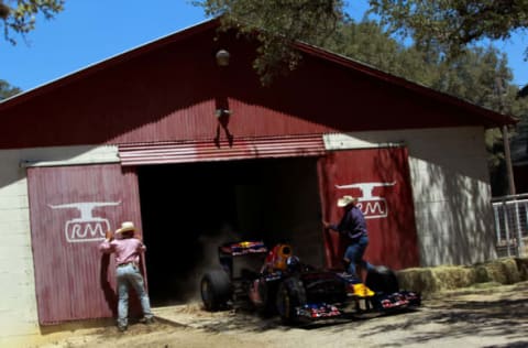 JOHNSON CITY, TX – AUGUST 19: Former Formula One driver David Coulthard of Great Britain drives the Red Bull Show Car out of a barn at a ranch on August 19, 2011 in Johnson City, Texas. (Photo by Tom Pennington/Getty Images for Red Bull)