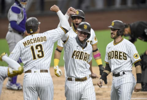 SAN DIEGO, CA – SEPTEMBER 8: Wil Myers #4 of the San Diego Padres, center, is congratulated by Manny Machado #13, Fernandfo Tatis Jr. #23 and Austin Nola #22 after hitting a grand slam. They’ll pose quite the postseason test for the SF Giants. (Photo by Denis Poroy/Getty Images)