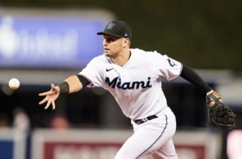 MIAMI, FL – SEPTEMBER 07: Joe Panik #12 of the Miami Marlins makes an error during a throw to first base during the sixth inning against the New York Mets at loanDepot park on September 7, 2021 in Miami, Florida. (Photo by Bryan Cereijo/Getty Images)