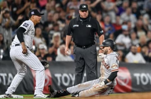 DENVER, CO – SEPTEMBER 7: Steven Duggar #6 of the San Francisco Giants slides into third base after hitting a fifth inning three-run triple as Rio Ruiz #14 of the Colorado Rockies waits for the throw at third base at Coors Field on September 7, 2021 in Denver, Colorado. (Photo by Dustin Bradford/Getty Images)