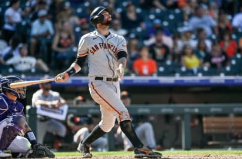 DENVER, CO – SEPTEMBER 26: Brandon Belt #9 of the San Francisco Giants hits a fifth inning double against the Colorado Rockies at Coors Field on September 26, 2021 in Denver, Colorado. (Photo by Dustin Bradford/Getty Images)