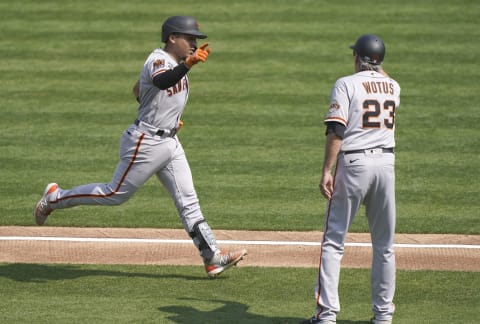 OAKLAND, CALIFORNIA – SEPTEMBER 20: Chadwick Tromp #14 of the SF Giants is congratulated by third base coach Ron Wotus #23 after Tromp hits a two-run home run against the Oakland Athletics in the top of the third inning at RingCentral Coliseum on September 20, 2020. (Photo by Thearon W. Henderson/Getty Images)