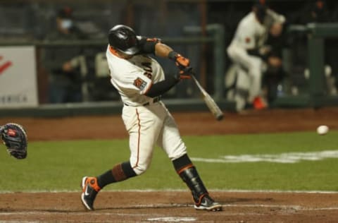 SAN FRANCISCO, CALIFORNIA – SEPTEMBER 21: Donovan Solano #7 of the San Francisco Giants hits an RBI single in the bottom of the fifth inning against the Colorado Rockies at Oracle Park on September 21, 2020 in San Francisco, California. (Photo by Lachlan Cunningham/Getty Images)