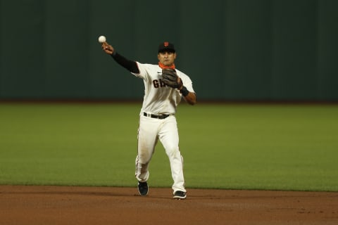 Donovan Solano #7 of the SF Giants fields the ball against the Colorado Rockies at Oracle Park on September 23, 2020, in San Francisco, California. (Photo by Lachlan Cunningham/Getty Images)