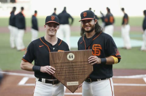 SAN FRANCISCO, CALIFORNIA – SEPTEMBER 26: Mike Yastrzemski #5 of the San Francisco Giants is presented with the 2020 Willie Mac Award by teammate Brandon Crawford #35 before the game against the San Diego Padres at Oracle Park on September 26, 2020, in San Francisco, California. (Photo by Lachlan Cunningham/Getty Images)