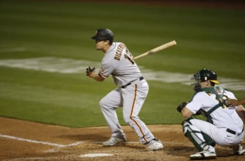 OAKLAND, CA – SEPTEMBER 18: Alex Dickerson #12 of the San Francisco Giants bats during the game against the Oakland Athletics at RingCentral Coliseum on September 18, 2020 in Oakland, California. The Athletics defeated the Giants 6-0. (Photo by Michael Zagaris/Oakland Athletics/Getty Images)