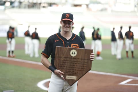 Mike Yastrzemski #5 of the SF Giants is presented with the 2020 Willie Mac Award by teammate Brandon Crawford #35 before the game against the San Diego Padres at Oracle Park on September 26, 2020. (Photo by Lachlan Cunningham/Getty Images)