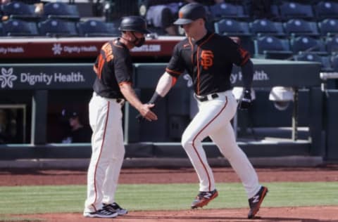 SCOTTSDALE, ARIZONA – MARCH 04: Mark Hallberg #91 high fives Joe McCarthy as he rounds third during the fifth inning of a spring training game against the Chicago White Sox at Scottsdale Stadium on March 04, 2021 in Scottsdale, Arizona. (Photo by Carmen Mandato/Getty Images)