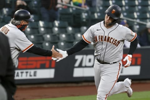 SEATTLE, WASHINGTON – APRIL 01: Buster Posey #28 of the SF Giants reacts after his home run against the Seattle Mariners in the second inning on Opening Day at T-Mobile Park on April 01, 2021. (Photo by Steph Chambers/Getty Images)