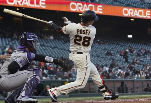 SAN FRANCISCO, CALIFORNIA – APRIL 26: Buster Posey #28 of the SF Giants hits an rbi double scoring Brandon Belt #9 against the Colorado Rockies in the first inning at Oracle Park on April 26, 2021 in San Francisco, California. (Photo by Thearon W. Henderson/Getty Images)