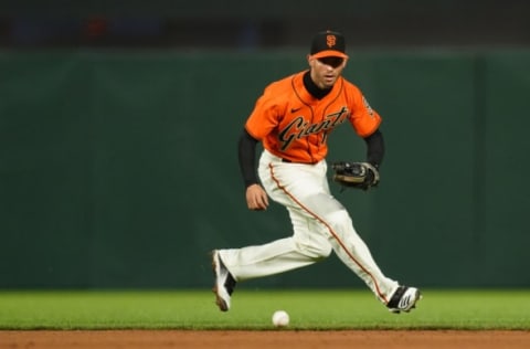 SAN FRANCISCO, CALIFORNIA – APRIL 23: Tommy La Stella #18 of the SF Giants fields a ball during the game against the Miami Marlins at Oracle Park on April 23, 2021 in San Francisco, California. (Photo by Daniel Shirey/Getty Images)