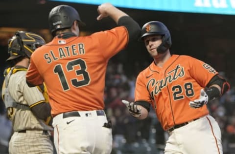 SAN FRANCISCO, CALIFORNIA – MAY 07: Buster Posey #28 of the SF Giants is congratulated by Austin Slater #13 after Posey hit a two-run home run against the San Diego Padres in the third inning at Oracle Park on May 07, 2021 in San Francisco, California. (Photo by Thearon W. Henderson/Getty Images)