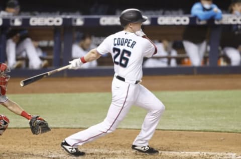 MIAMI, FLORIDA – MAY 24: Garrett Cooper #26 of the Miami Marlins in action against the Philadelphia Phillies at loanDepot park on May 24, 2021 in Miami, Florida. (Photo by Michael Reaves/Getty Images)