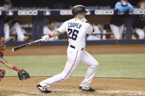 MIAMI, FLORIDA – MAY 24: Garrett Cooper #26 of the Miami Marlins in action against the Philadelphia Phillies at loanDepot park on May 24, 2021. (Photo by Michael Reaves/Getty Images)