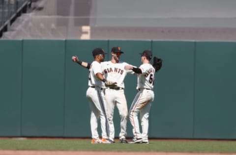 SAN FRANCISCO, CALIFORNIA – JUNE 17: San Francisco Giants players LaMonte Wade Jr #31, Steven Duggar #6 and Mike Yastrzemski #5 celebrate a win against the Arizona Diamondbacks at Oracle Park on June 17, 2021 in San Francisco, California. (Photo by Lachlan Cunningham/Getty Images)