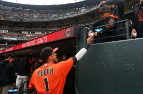 SAN FRANCISCO, CALIFORNIA – JUNE 25: Mauricio Dubon #1 of the SF Giants signs an autograph for a fan before the game against the Oakland Athletics at Oracle Park on June 25, 2021 in San Francisco, California. (Photo by Lachlan Cunningham/Getty Images)