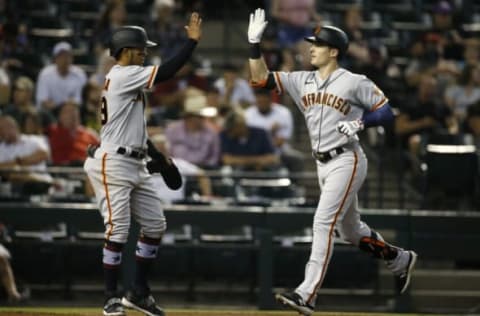 PHOENIX, ARIZONA – JULY 03: Mike Yastrzemski #5 of the SF Giants (R) is congratulated as he crosses the plate by Thairo Estrada #39 of the Giants after hitting a two-run home run against the Arizona Diamondbacks during the third inning of the MLB game at Chase Field on July 03, 2021 in Phoenix, Arizona. (Photo by Ralph Freso/Getty Images)