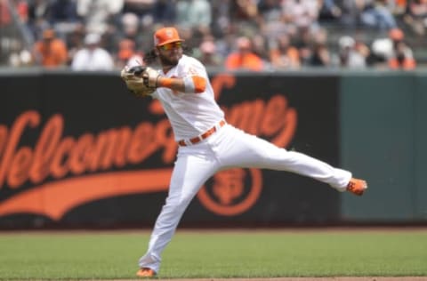 SAN FRANCISCO, CALIFORNIA – JULY 11: Brandon Crawford #35 of the San Francisco Giants throws to first base off balance but not in time to get Starlin Castro #13 of the Washington Nationals in the top of the second inning at Oracle Park on July 11, 2021 in San Francisco, California. The Giants are wearing an alternate uniform called City Connect. (Photo by Thearon W. Henderson/Getty Images)