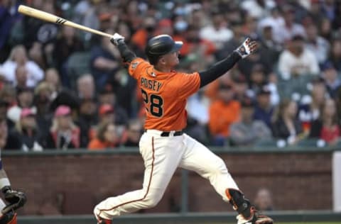 SAN FRANCISCO, CALIFORNIA – JULY 30: Buster Posey #28 of the San Francisco Giants swings and watches the flight of his ball as he hits an RBI double scoring pitcher Kevin Gausman #34 against the Houston Astros in the bottom of the third inning at Oracle Park on July 30, 2021 in San Francisco, California. (Photo by Thearon W. Henderson/Getty Images)