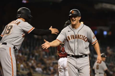 PHOENIX, ARIZONA – AUGUST 04: Alex Dickerson #12 of the San Francisco Giants celebrates with Tommy La Stella #18 after scoring on a two-run single off the bat of Donovan Solano against the Arizona Diamondbacks in the sixth inning at Chase Field on August 04, 2021 in Phoenix, Arizona. (Photo by Norm Hall/Getty Images)