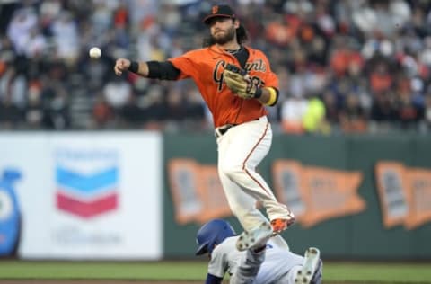 SAN FRANCISCO, CALIFORNIA – SEPTEMBER 03: Brandon Crawford #35 of the San Francisco Giants throws to first base while leaping over Trea Turner #6 of the Los Angeles Dodgers in the top of the first inning at Oracle Park on September 03, 2021 in San Francisco, California. The throw was not in time to get an out on Max Muncy #13. (Photo by Thearon W. Henderson/Getty Images)