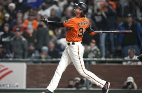 SAN FRANCISCO, CALIFORNIA – SEPTEMBER 17: Kevin Gausman #34 of the San Francisco Giants hits a pinch hit sacrifice fly to score Brandon Crawford #35 with a walk off win in the bottom of the 11th inning against the Atlanta Braves at Oracle Park on September 17, 2021 in San Francisco, California. The Giants won the game 6-5. (Photo by Thearon W. Henderson/Getty Images)