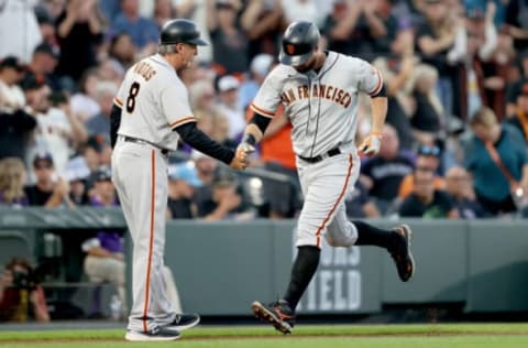 DENVER, COLORADO – SEPTEMBER 25: Brandon Belt #9 of the San Francisco Giants is congratulated by Ron Wotus #23 as circles the bases after hitting a solo home run against the Colorado Rockies in the first inning at Coors Field on September 25, 2021 in Denver, Colorado. (Photo by Matthew Stockman/Getty Images)