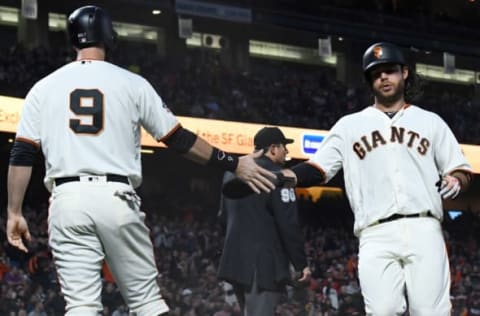 SAN FRANCISCO, CA – MAY 14: Brandon Belt #9 and Brandon Crawford #35 of the San Francisco Giants slap hands after they both scored on a bases loaded two-run rbi single from Kelby Tomlinson #37 against the Cincinnati Reds in the bottom of the third inning at AT&T Park on May 14, 2018 in San Francisco, California. (Photo by Thearon W. Henderson/Getty Images)