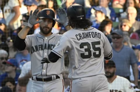 CHICAGO, IL – MAY 26: Brandon Crawford #35 of the San Francisco Giants is greeted by Mac Williamson #51after hitting a two-run homer against the Chicago Cubs during the fourth inning on May 26, 2018 at Wrigley Field in Chicago, Illinois. (Photo by David Banks/Getty Images)