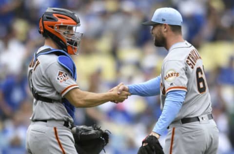 LOS ANGELES, CA – JUNE 17: Nick Hundley #5 of the San Francisco Giants shakes hands with Hunter Strickland #60 of the San Francisco Giants after the game against the Los Angeles Dodgers at Dodger Stadium on June 17, 2018 in Los Angeles, California. The Giants won 4-1. (Photo by John McCoy/Getty Images)