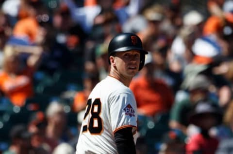 SAN FRANCISCO, CA – JULY 15: Buster Posey #28 of the San Francisco Giants returns to the dugout after striking out against the Oakland Athletics during the ninth inning at AT&T Park on July 15, 2018 in San Francisco, California. The Oakland Athletics defeated the San Francisco Giants 6-2. (Photo by Jason O. Watson/Getty Images)