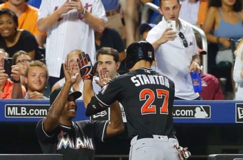 NEW YORK, NY – JULY 05: Giancarlo Stanton #27 of the Miami Marlins celebrates his eighth inning three-run home run against the New York Mets with hitting coach Barry Bonds at Citi Field on July 5, 2016 in the Flushing neighborhood of the Queens borough of New York City. (Photo by Jim McIsaac/Getty Images)