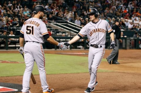 PHOENIX, AZ – SEPTEMBER 25: Kelby Tomlinson #37 of the San Francisco Giants (R) is congratulated by teammate Mac Williamson #51 after scoring against the Arizona Diamondbacks during the eighth inning of a MLB game at Chase Field on September 25, 2017 in Phoenix, Arizona. The Giants defeated the Diamondbacks 9-2. (Photo by Ralph Freso/Getty Images)