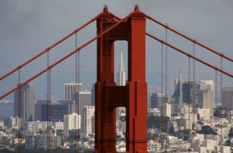 SAUSALITO, CA – JUNE 20: The Transamerica Pyramid building is seen through the north tower of the Golden Gate Bridge June 20, 2007 as seen from Sausalito, California. Pacific Gas and Electric has launched an estimated $1.5 million research program to study the possibility of submerging turbines under the water to gather energy from tidal flows. A previous study conducted by the Electric Power Research Institute in 2006 came to conclude that the tides that pass under the iconic Golden Gate bridge are the best on the West Coast of the U.S. to generate power. (Photo by Justin Sullivan/Getty Images)