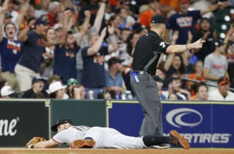 HOUSTON, TX – MAY 22: Third base umpire Mike Muchlinski signals a fair ball after Evan Longoria #10 of the San Francisco Giants dives for and misses 2a ball hit by Jose Altuve #27 of the Houston Astros in the sixth inning at Minute Maid Park on May 22, 2018 in Houston, Texas. (Photo by Bob Levey/Getty Images)