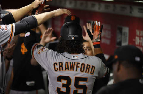 PHOENIX, AZ – JUNE 30: Brandon Crawford #35 of the San Francisco Giants celebrates with teammates in the dugout after hitting a solo home run off of Shelby Miller #26 of the Arizona Diamondbacks during the second inning at Chase Field on June 30, 2018 in Phoenix, Arizona. (Photo by Norm Hall/Getty Images)