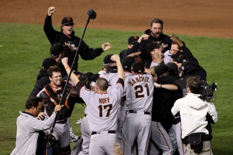 ARLINGTON, TX – NOVEMBER 01: Catcher Buster Posey #28, Aubrey Huff #17, Freddy Sanchez #21 and Matt Cain #18 (top L) of the San Francisco Giants celebrate on the field with their teammates after the Giants won 3-1 against the Texas Rangers in Game Five of the 2010 MLB World Series at Rangers Ballpark in Arlington on November 1, 2010 in Arlington, Texas. (Photo by Elsa/Getty Images)