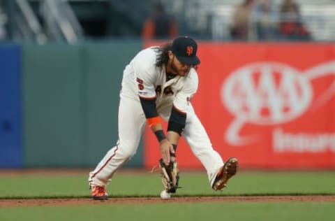 SAN FRANCISCO, CA – APRIL 11: Brandon Crawford #35 of the San Francisco Giants fumbles a ball hit by Tony Wolters #14 of the Colorado Rockies in the top of the second inning at Oracle Park on April 11, 2019 in San Francisco, California. (Photo by Lachlan Cunningham/Getty Images)