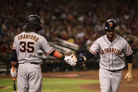 SF Giants shortstop Brandon Crawford and first baseman Brandon Belt slap hands. (Photo by Jennifer Stewart/Getty Images)