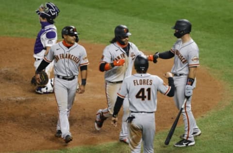 DENVER, CO – SEPTEMBER 01: Brandon Crawford #35 of the SF Giants (C) is congratulated by Donovan Solano #7 (2L), Wilmer Flores #41 and Joey Bart #21 as catcher Tony Wolters #14 of the Colorado Rockies kneels behind the plate during the sixth inning at Coors Field on September 1, 2020 in Denver, Colorado. (Photo by Justin Edmonds/Getty Images)