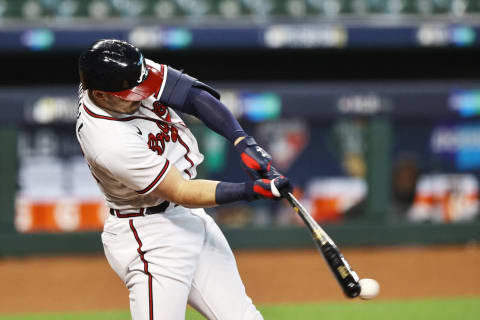 HOUSTON, TEXAS – OCTOBER 07: Adam Duvall #23 of Atlanta hits a single during the fifth inning against the Miami Marlins in Game Two of the National League Division Series at Minute Maid Park on October 07, 2020 in Houston, Texas. (Photo by Elsa/Getty Images)