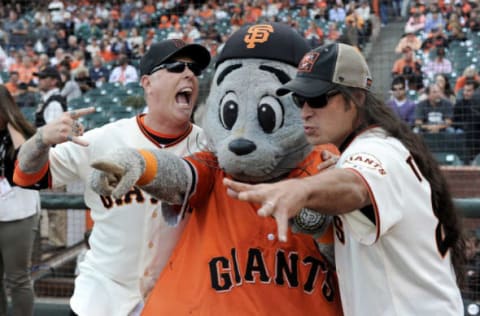 SAN FRANCISCO, CA – OCTOBER 15: James Hetfield and ?Robert Trujillo of Metallica pose with Lou Seal before Game Four of the National League Championship Series at AT&T Park on October 15, 2014 in San Francisco, California. (Photo by Harry How/Getty Images)