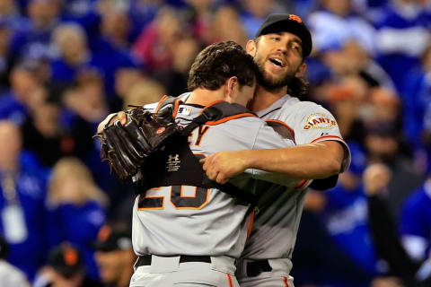 KANSAS CITY, MO – OCTOBER 29: Buster Posey #28 and Madison Bumgarner #40 of the San Francisco Giants celebrate after defeating the Kansas City Royals to win Game Seven of the 2014 World Series by a score of 3-2 at Kauffman Stadium on October 29, 2014, in Kansas City, Missouri. (Photo by Jamie Squire/Getty Images)