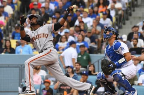 LOS ANGELES, CA – JUNE 16: Austin Barnes #15 of the Los Angeles Dodgers looks on as Alen Hanson #19 of the San Francisco Giants hits a sacrifice fly to score Mac Williamson #51 of the San Francisco Giants in the fifth inning of the game at Dodger Stadium on June 16, 2018 in Los Angeles, California. (Photo by Jayne Kamin-Oncea/Getty Images)